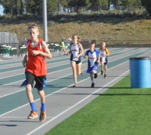 Several young athletes participate in the 1500 meter race at Summit High School.