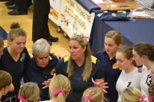 COOPER STRATEGIZES WITH THE TEAM. 